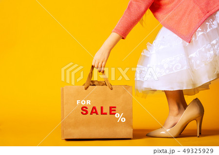 little girl in oversized shoes, taking a paper bag with an inscription sale little girl in oversized shoes, taking a paper bag with an inscription sale 49325929