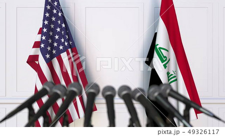 Flags of the United States and Iraq at international meeting or negotiations press conference. 3D Flags of the United States and Iraq at international meeting or negotiations press conference. 3D 49326117