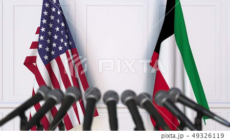 Flags of the United States and Kuwait at international meeting or negotiations press conference. 3D Flags of the United States and Kuwait at international meeting or negotiations press conference. 3D 49326119