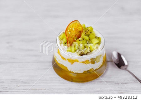 kiwi and peach trifle, appetizing cold dessert  kiwi and peach trifle, appetizing cold dessert  49328312