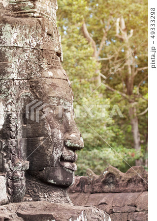 Massive stone carving faces of Bayon temple in 49333298