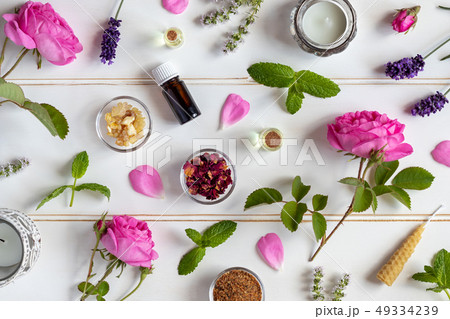 Bottles of essential oil with roses, peppermint, 49334239