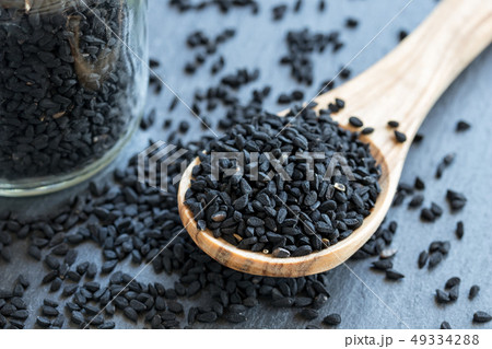 Black cumin seeds on a wooden spoon Black cumin seeds on a wooden spoon 49334288