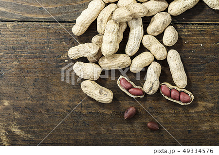 raw peanuts scattered 49334576