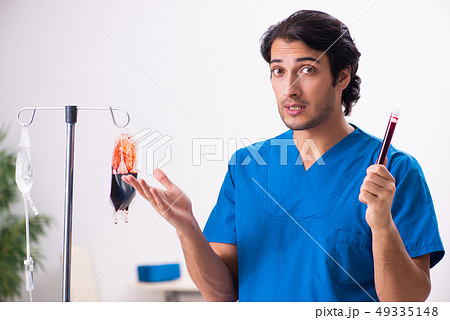 Young male doctor in blood transfusion concept  49335148