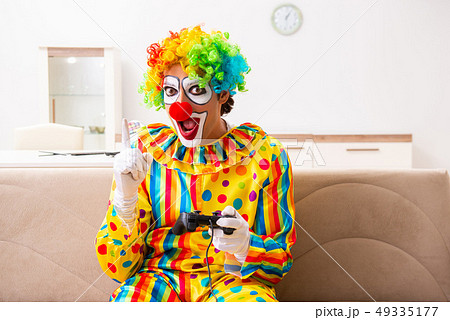 Male clown preparing for perfomance at home  49335177