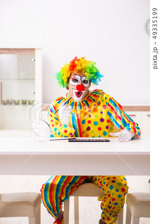 Male clown preparing for perfomance at home Male clown preparing for perfomance at home 49335199