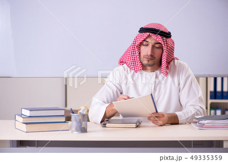 Arab teacher in front of whiteboard Arab teacher in front of whiteboard 49335359
