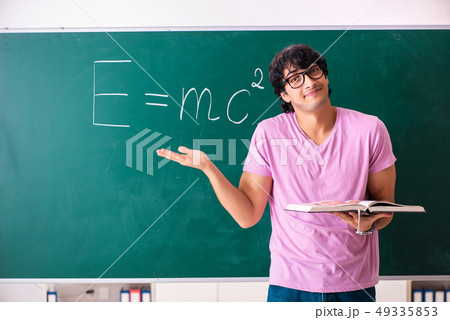 Young male physic standing in front of the green board 49335853