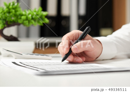 Businessman working in office and calculating Businessman working in office and calculating 49336511