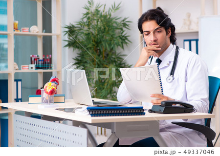Young doctor cardiologist working in the clinic Young doctor cardiologist working in the clinic 49337046