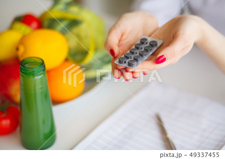 Diet. Female Nutritionist Holding Blisters of Pills Diet. Female Nutritionist Holding Blisters of Pills 49337455
