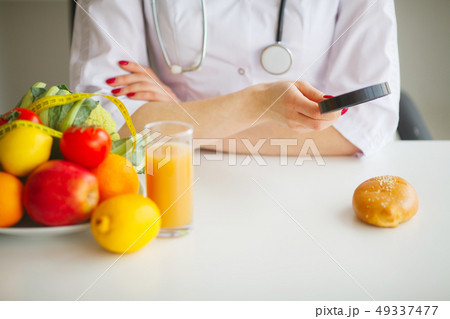 Some Fruits Such As Apples, Kiwis, Lemons And Berries On Nutritionist Table 49337477