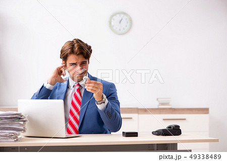 Deaf employee using hearing aid in office 49338489
