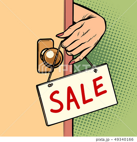 sale woman hand hangs a sign on the door 49340166