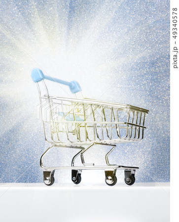 Trolley for shopping on a pedestal on a winter blue background with a glow. Best Buyer, Best Buy. 49340578