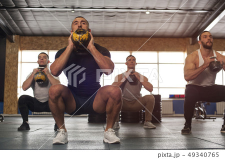 Multi-ethnic Group of Male Athletes Training in Gym 49340765