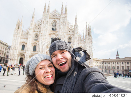 Travel, Italy and funny couple concept - Happy tourists taking a self portrait with pigeons in front 49344324