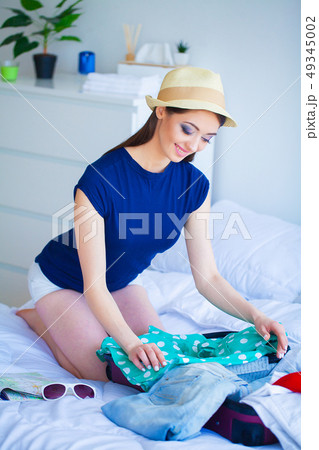 Vacation. Woman Who is Preparing for Rest. Young Beautiful Girl Sits on the Bed. Portrait of a Vacation. Woman Who is Preparing for Rest. Young Beautiful Girl Sits on the Bed. Portrait of a 49345002
