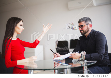Business. Business Woman Gives Money to Men. Woman Dressed in Red Dress Gives Bribe. Business Man In 49345142