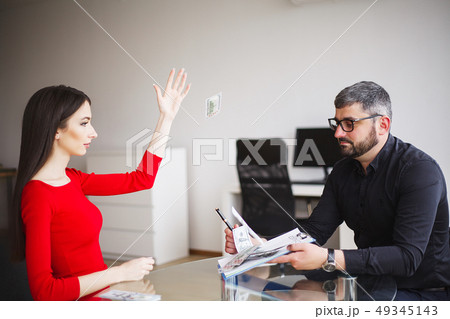 Business Woman Gives Money to Men. Woman Dressed in Red Dress Gives Bribe. Business Man In Gray Business Woman Gives Money to Men. Woman Dressed in Red Dress Gives Bribe. Business Man In Gray 49345143