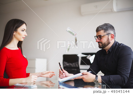 Business Woman Gives Money to Men. Woman Dressed in Red Dress Gives Bribe. Business Man In Gray Business Woman Gives Money to Men. Woman Dressed in Red Dress Gives Bribe. Business Man In Gray 49345144