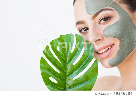 Skincare. Beautiful Woman With Perfect Skin Near Green Leaf Over White Background Skincare. Beautiful Woman With Perfect Skin Near Green Leaf Over White Background 49346584