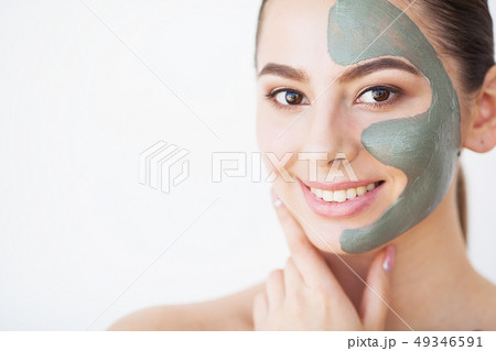 Skin Care. Young Woman With Cosmetic Clay Mask Holding Cucumber At Her Bathroom 49346591
