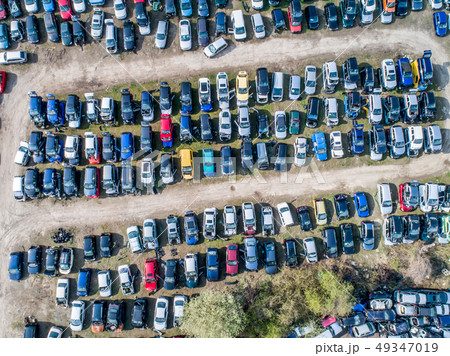 Lines of crushed cars wreck in scrapyard before being shredded recyling 49347019