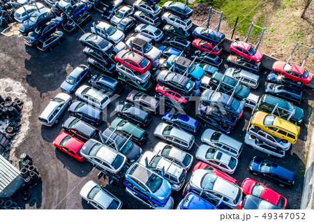 Lines of crushed cars wreck in scrapyard before being shredded recyling 49347052