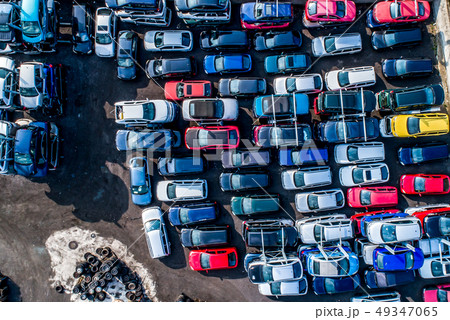 Lines of crushed cars wreck in scrapyard before being shredded recyling 49347065