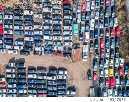 Lines of crushed cars wreck in scrapyard before being shredded recyling 49347076