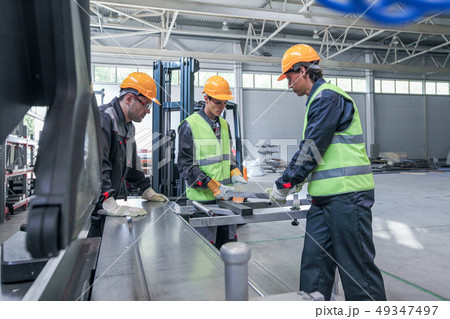 Team of workers in CNC factory Team of workers in CNC factory 49347497