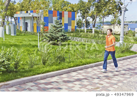 Man running along waterfront Man running along waterfront 49347969