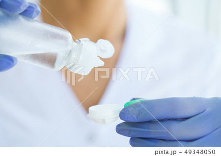 Vision And Medicine Concept. Young Girl Holds Eye Drops In Hands. Portrait of a Beautiful Woman with 49348050