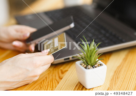 Desk with various gadgets and office supplies 49348427