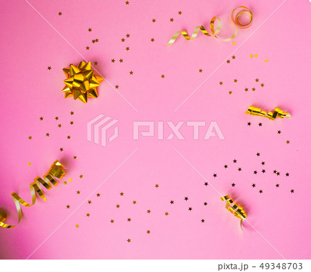 Golden decorations and sparkles on pink background 49348703