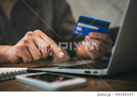 Businessman holding credit card and typing on 49349147