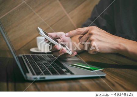 Businessman holding credit card and using 49349228