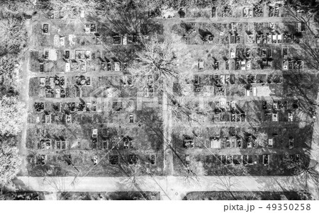 Aerial drone view of a church graveyard cemetary Germany black and white 49350258