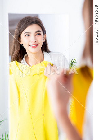 asian girl trying dress happily 49353559