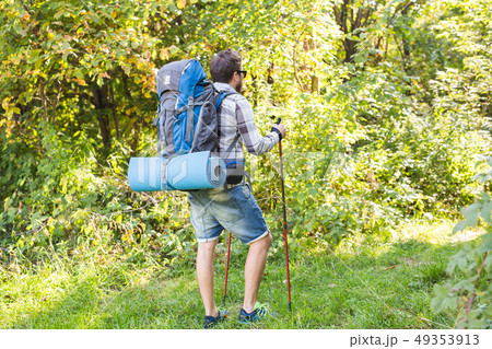Hike, tourism and nature concept - Young traveler with backpack standing over forest background 49353913