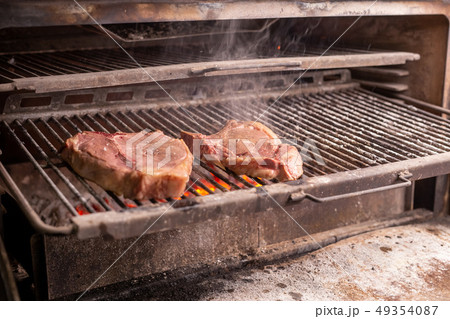 food, craft and delicious concept - cooking steak on a grill food, craft and delicious concept - cooking steak on a grill 49354087