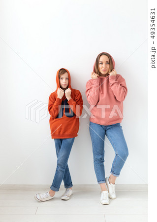 Mothers day, children and family concept - teen boy hugging his mom on white background 49354631