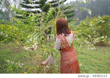 Beautiful girl resting herself in the garden Beautiful girl resting herself in the garden 49362213