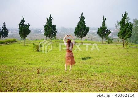Beautiful girl resting herself in the garden Beautiful girl resting herself in the garden 49362214