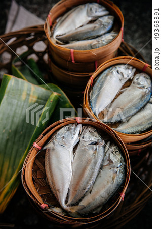 Fresh raw makerel fish in bamboo tray on banana Fresh raw makerel fish in bamboo tray on banana 49363391