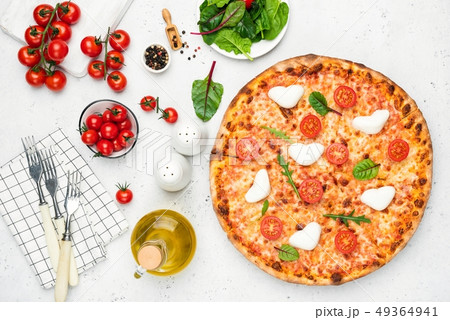 Italian pizza with heart shaped mozzarella, tomatoes and basil 49364941