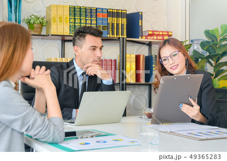 CEO or chief financial officer sees financial summary reports with his secretary team and discusses 49365283