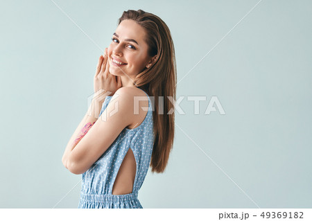 Happy smiling beautiful woman posing in light Happy smiling beautiful woman posing in light 49369182